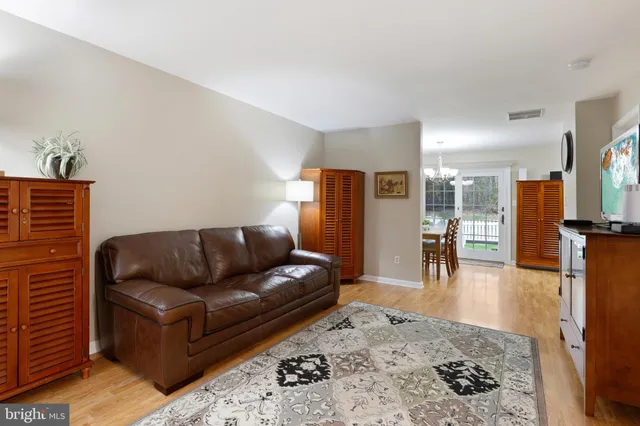 a view of a dining room with furniture wooden floor and a chandelier