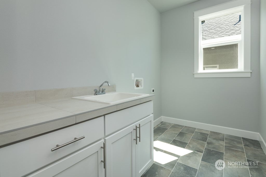 2720 Arrowroot Street Southeast Lacey, WA 98513 - Photo 11 of 18 a bathroom with a sink and a vanity