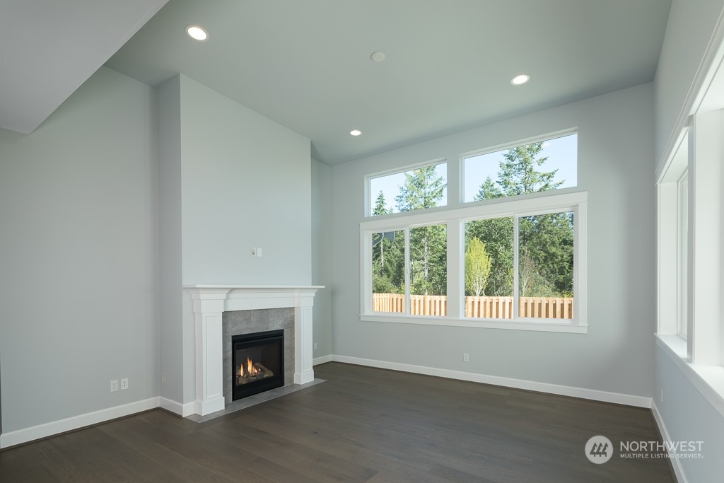2720 Arrowroot Street Southeast Lacey, WA 98513 - Photo 4 of 18 an empty room with windows and fireplace
