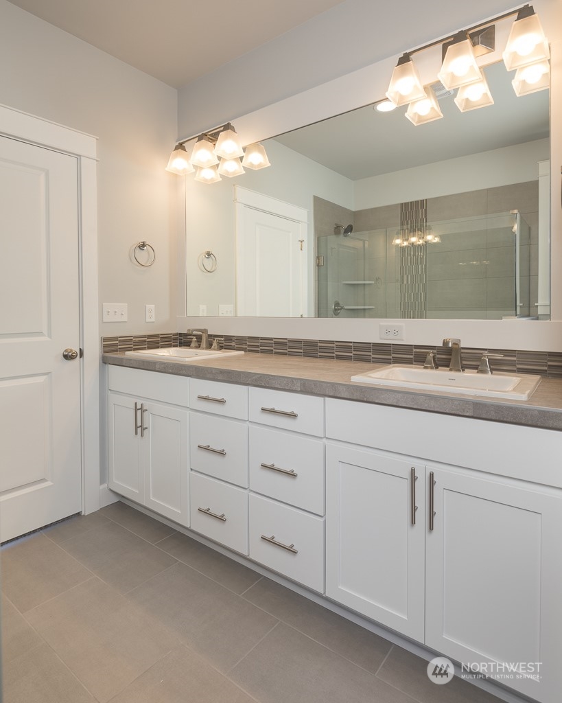 2720 Arrowroot Street Southeast Lacey, WA 98513 - Photo 7 of 18 a bathroom with a sink and mirror