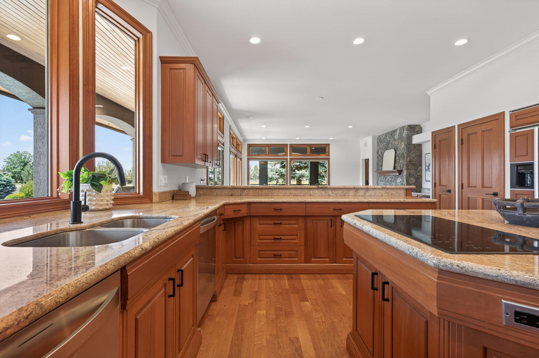 20180 Winston Loop Bend, OR 97703 - Photo 15 of 59 a kitchen with stainless steel appliances granite countertop a sink and dishwasher next to a large window