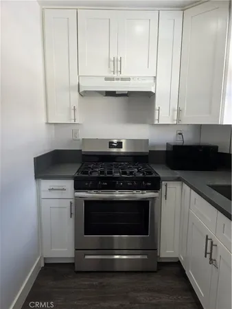 a stove top oven sitting inside of a kitchen