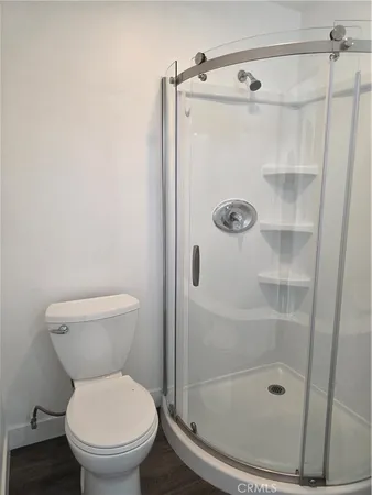 a bathroom with a shower toilet and a shower