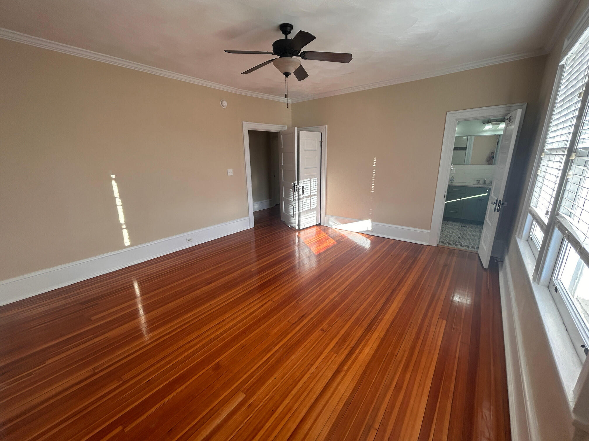 360 Walnut Avenue Southwest, Unit B Roanoke, VA 24016 - Photo 39 of 60 a view of an empty room with wooden floor and a ceiling fan