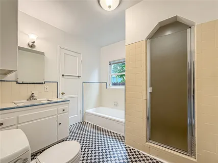 a bathroom with a sink a toilet a shower and a mirror