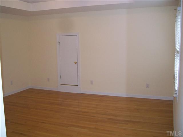 3520 Barron Berkeley Way Raleigh, NC 27612 - Photo 9 of 16 a view of an empty room with wooden floor and a window