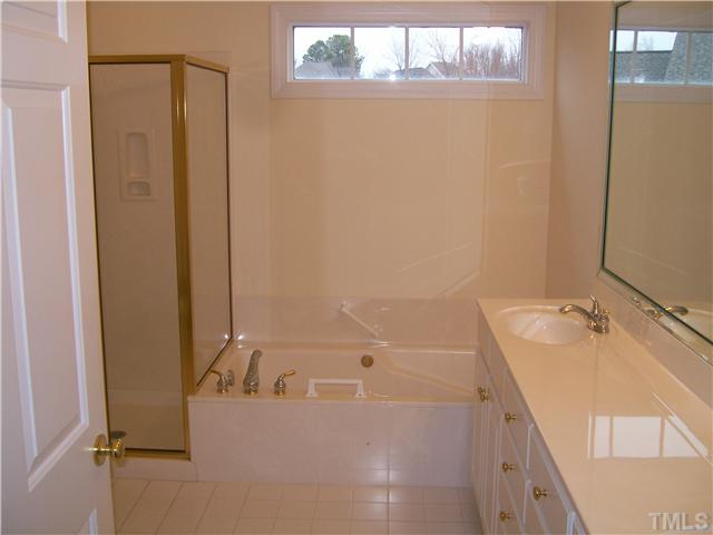 3520 Barron Berkeley Way Raleigh, NC 27612 - Photo 10 of 16 a bathroom with a tub sink and mirror