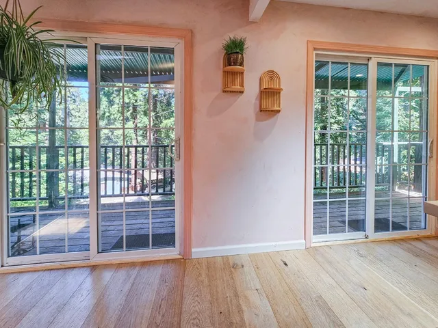 a view of wooden floor and windows in a room