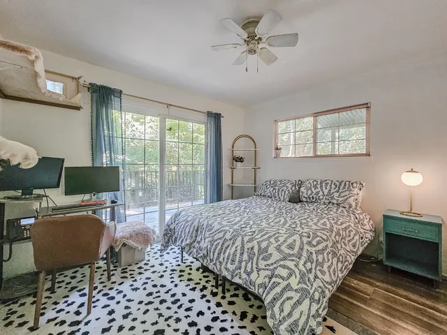 a bedroom with a large bed and a chandelier