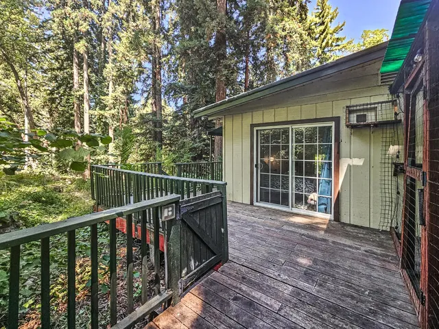 a view of a balcony with wooden floor and fence