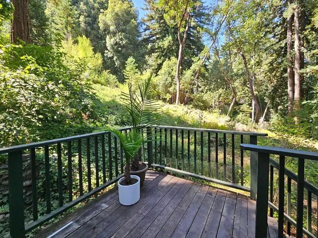 a view of a balcony with wooden floor