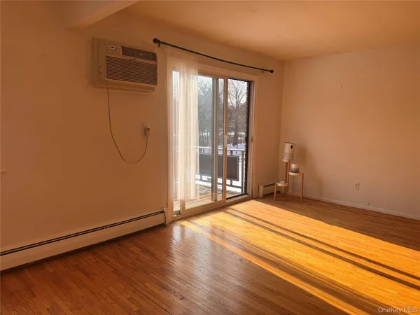 a view of a room with wooden floor and windows