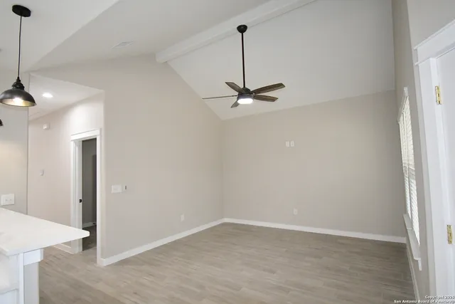 a view of a room with a sink and cabinets