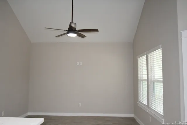 a view of a small space with wooden floor and a window