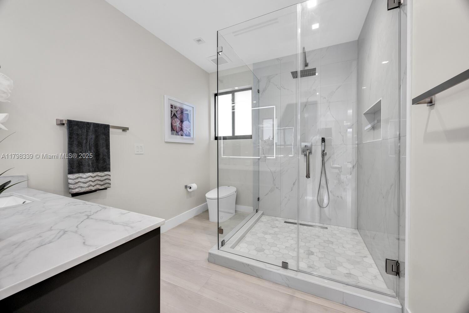 3224 Elizabeth Street Miami, FL 33133 - Photo 16 of 30 a bathroom with a sink a toilet a mirror and shower