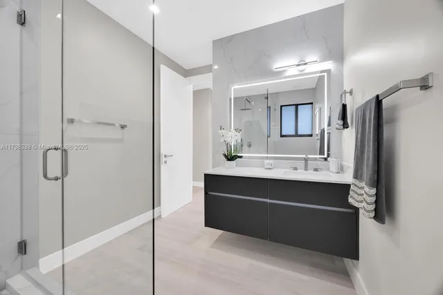 a bathroom with a double vanity sink mirror and shower