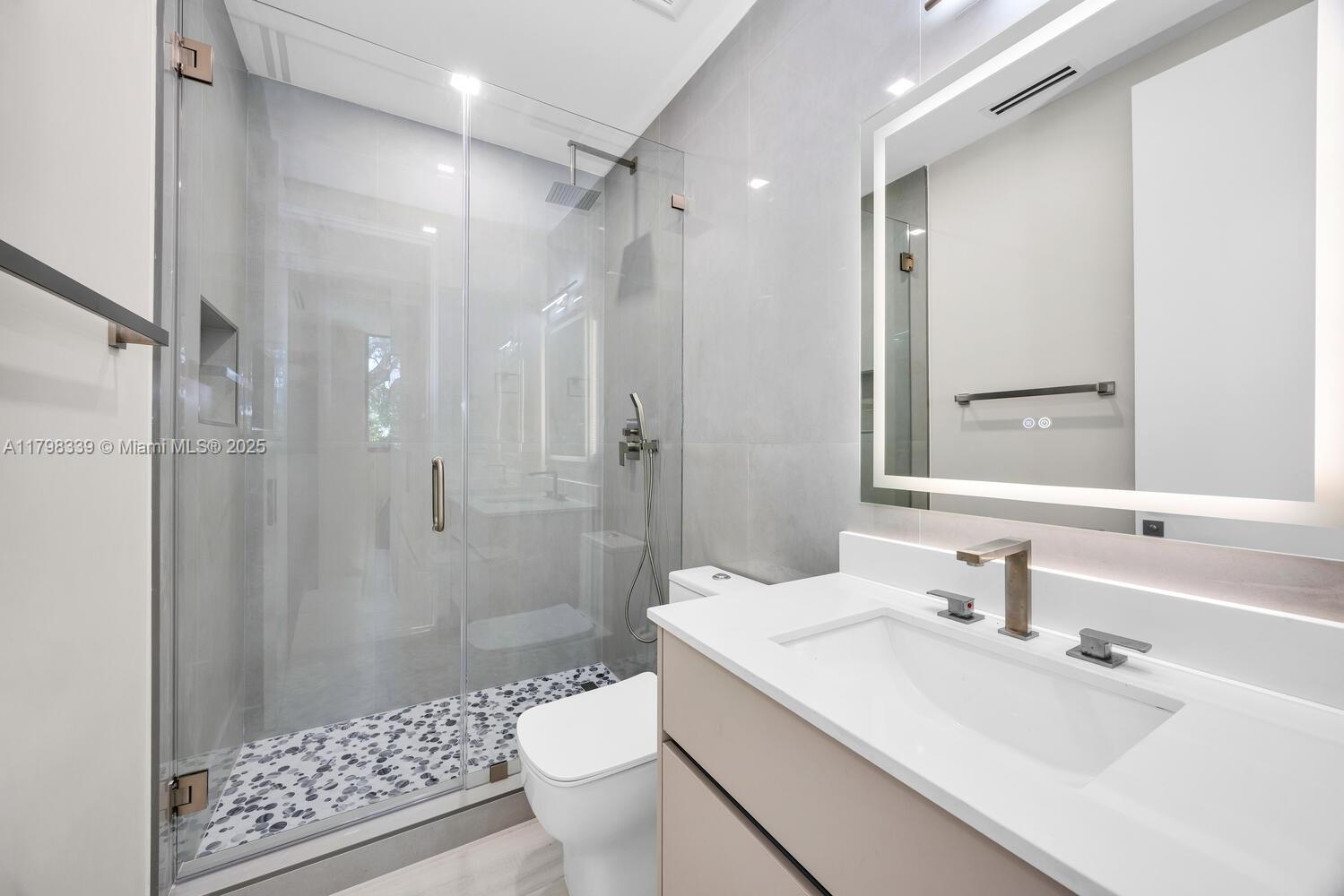 3224 Elizabeth Street Miami, FL 33133 - Photo 21 of 30 a bathroom with a sink toilet a shower and a mirror