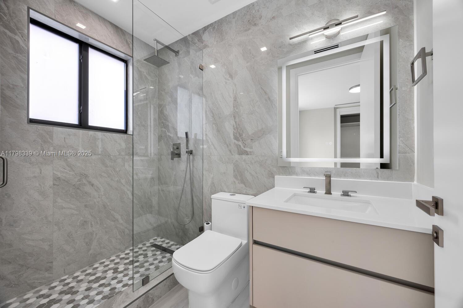 3224 Elizabeth Street Miami, FL 33133 - Photo 22 of 30 a bathroom with a sink toilet a mirror and shower