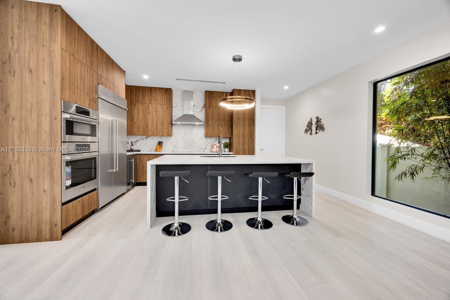 3224 Elizabeth Street Miami, FL 33133 - Photo 9 of 30 a kitchen with stainless steel appliances a stove and a refrigerator