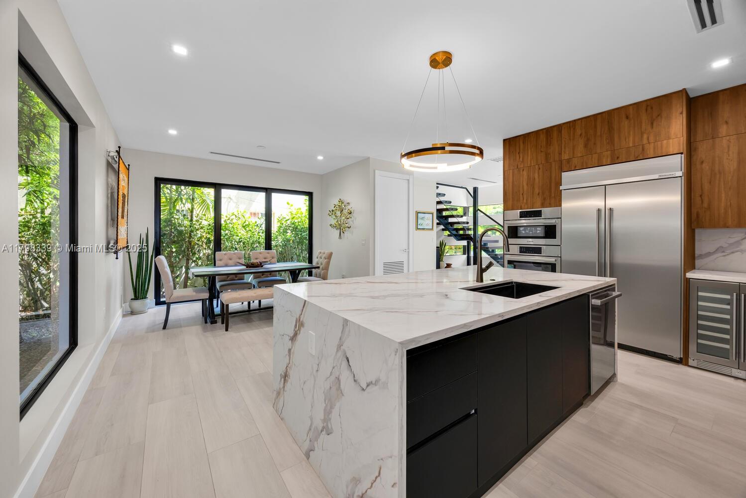 3224 Elizabeth Street Miami, FL 33133 - Photo 10 of 30 a kitchen with stainless steel appliances granite countertop a sink and a refrigerator