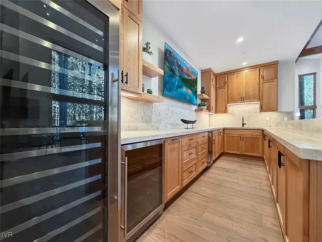 a kitchen with stainless steel appliances granite countertop wooden cabinets and a granite counter tops