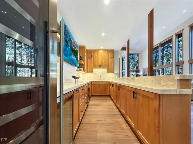 a kitchen with stainless steel appliances granite countertop a sink and stove