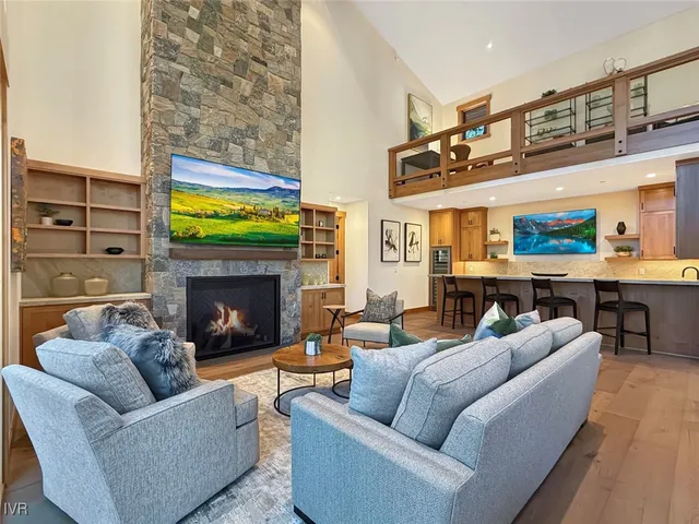 a spacious bedroom with a bed a couch and large window