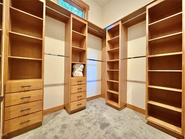 a dining room with furniture a rug and a large window