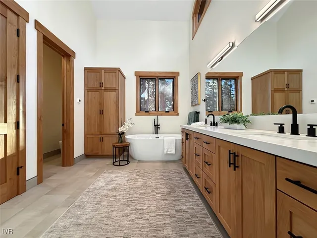 a bathroom with a granite countertop sink a toilet a shower and a mirror