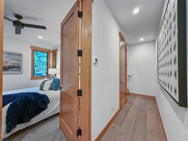 a spacious bedroom with a bed and large windows