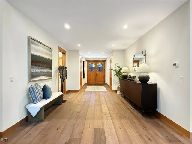 a dining room with wooden floor and a table