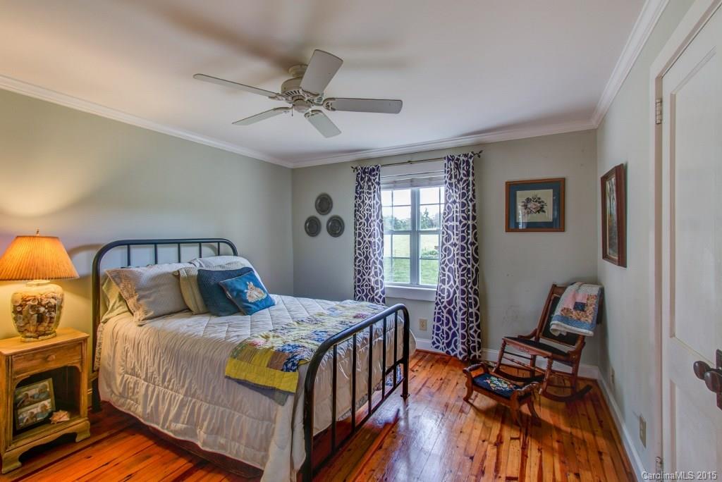 4031 Tite Road Stanfield, NC 28163 - Photo 11 of 24 a bedroom with a bed and wooden floor