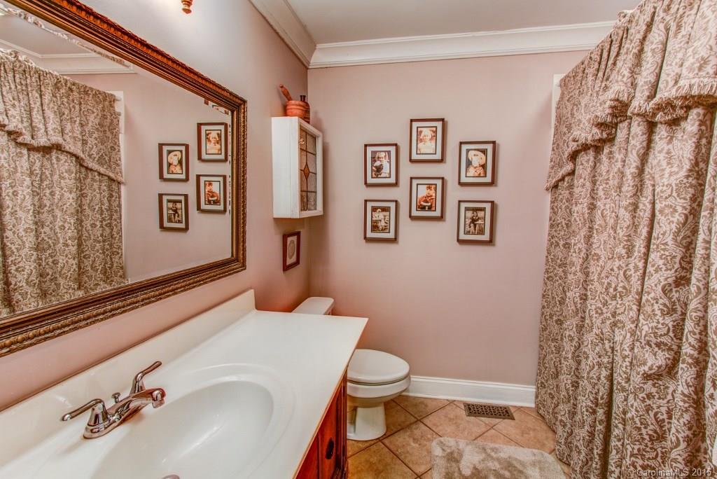 4031 Tite Road Stanfield, NC 28163 - Photo 12 of 24 a bathroom with a sink and a mirror