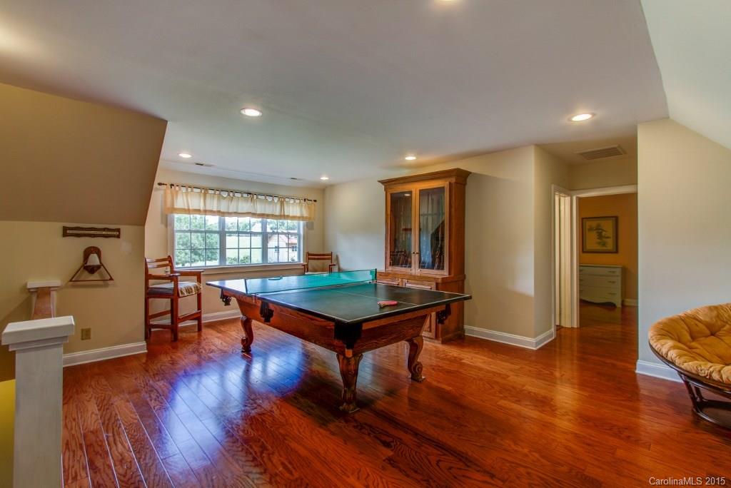 4031 Tite Road Stanfield, NC 28163 - Photo 13 of 24 a room with furniture pool table wooden floor and windows