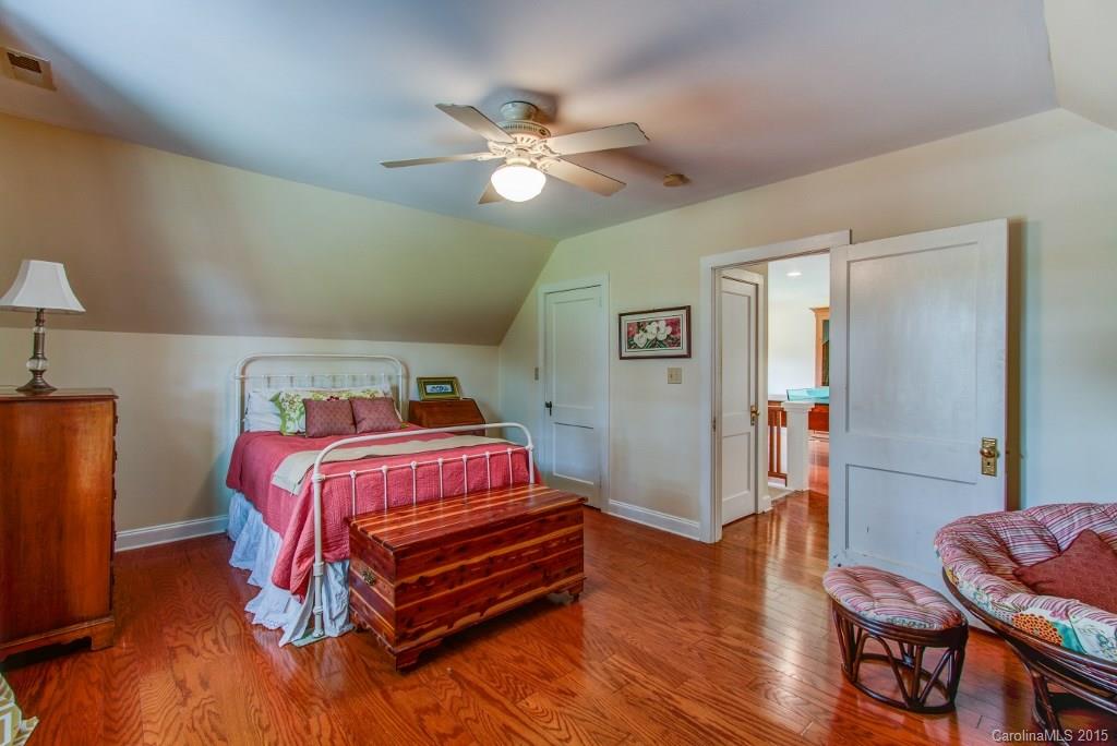 4031 Tite Road Stanfield, NC 28163 - Photo 15 of 24 a bedroom with a bed and wooden floor