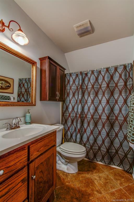 4031 Tite Road Stanfield, NC 28163 - Photo 16 of 24 a bathroom with a sink a toilet and mirror