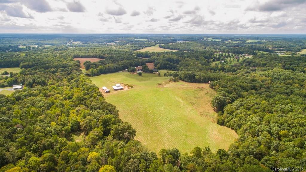 4031 Tite Road Stanfield, NC 28163 - Photo 24 of 24 a view of a lake with a mountain in the background