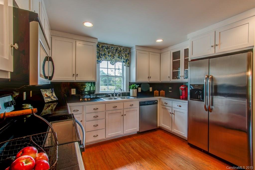 4031 Tite Road Stanfield, NC 28163 - Photo 4 of 24 a kitchen with stainless steel appliances granite countertop a refrigerator sink and cabinets