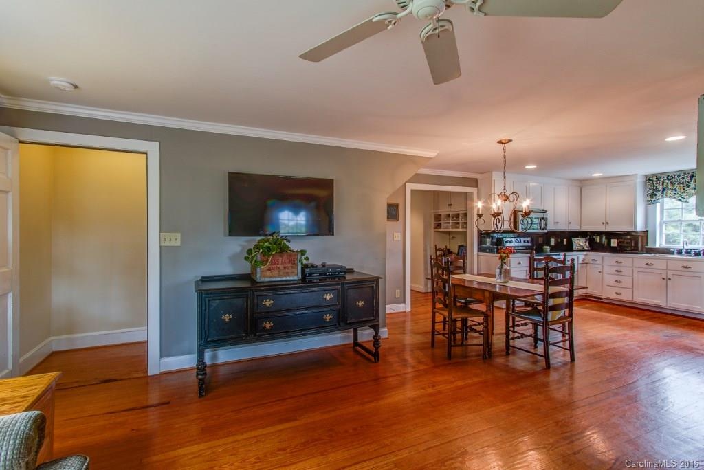 4031 Tite Road Stanfield, NC 28163 - Photo 5 of 24 a living room with furniture and a dining table with wooden floor