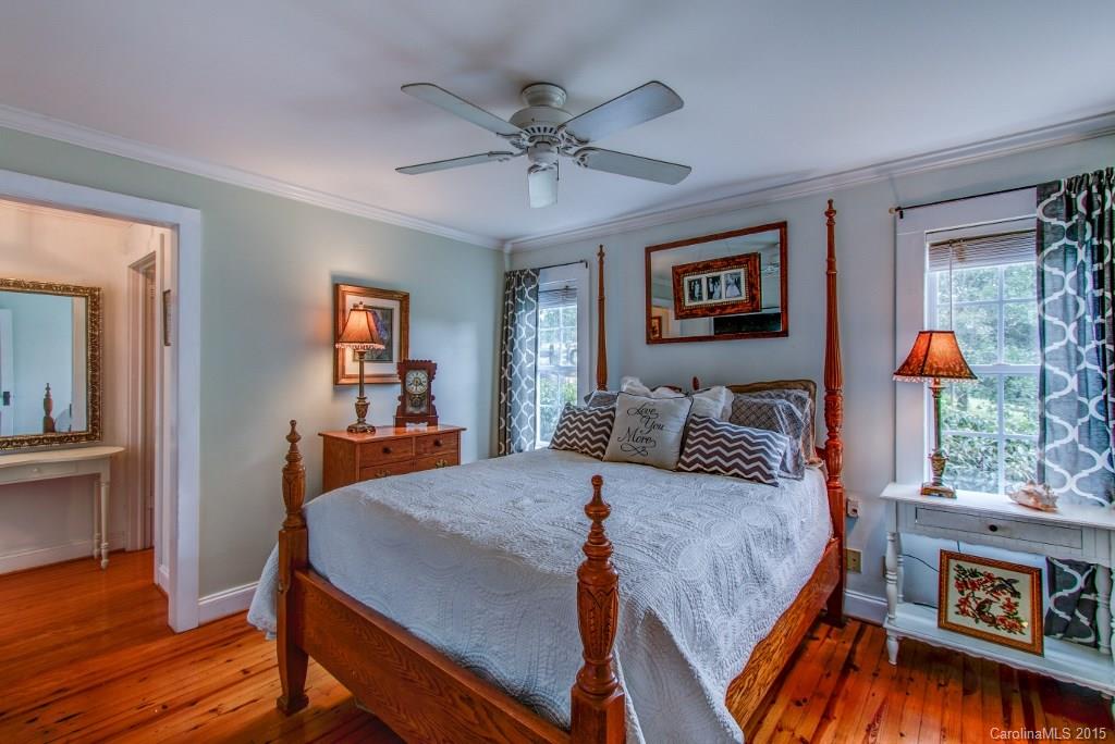 4031 Tite Road Stanfield, NC 28163 - Photo 8 of 24 a bed room with a bed and a chandelier