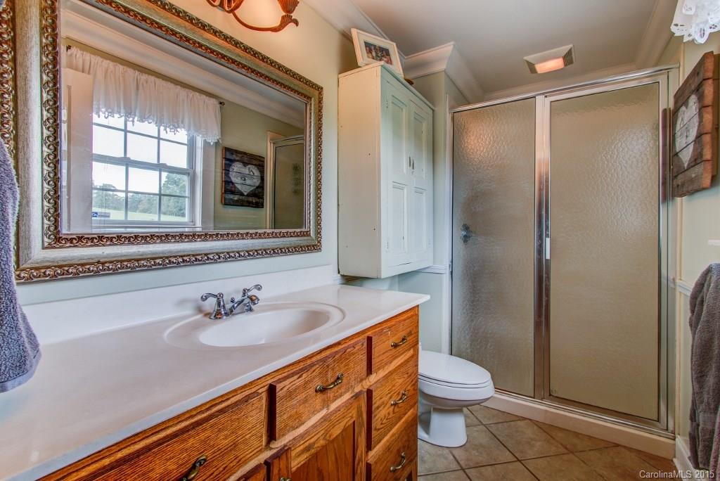 4031 Tite Road Stanfield, NC 28163 - Photo 9 of 24 a bathroom with a sink toilet and shower