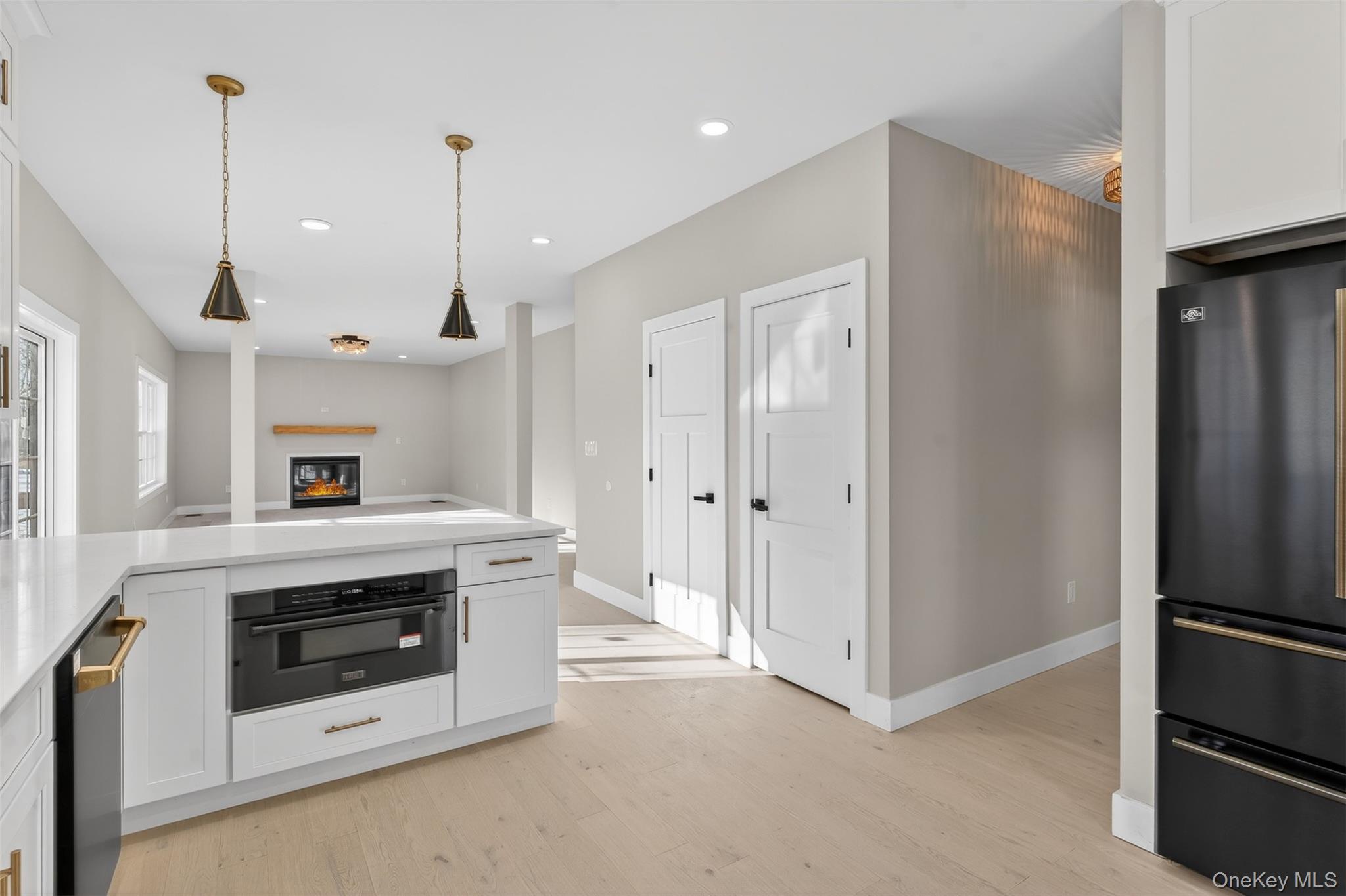14 Harness Road Goshen, NY 10924 - Photo 40 of 40 Kitchen with white cabinets, freestanding refrigerator, decorative light fixtures, open floor plan, and recessed lighting