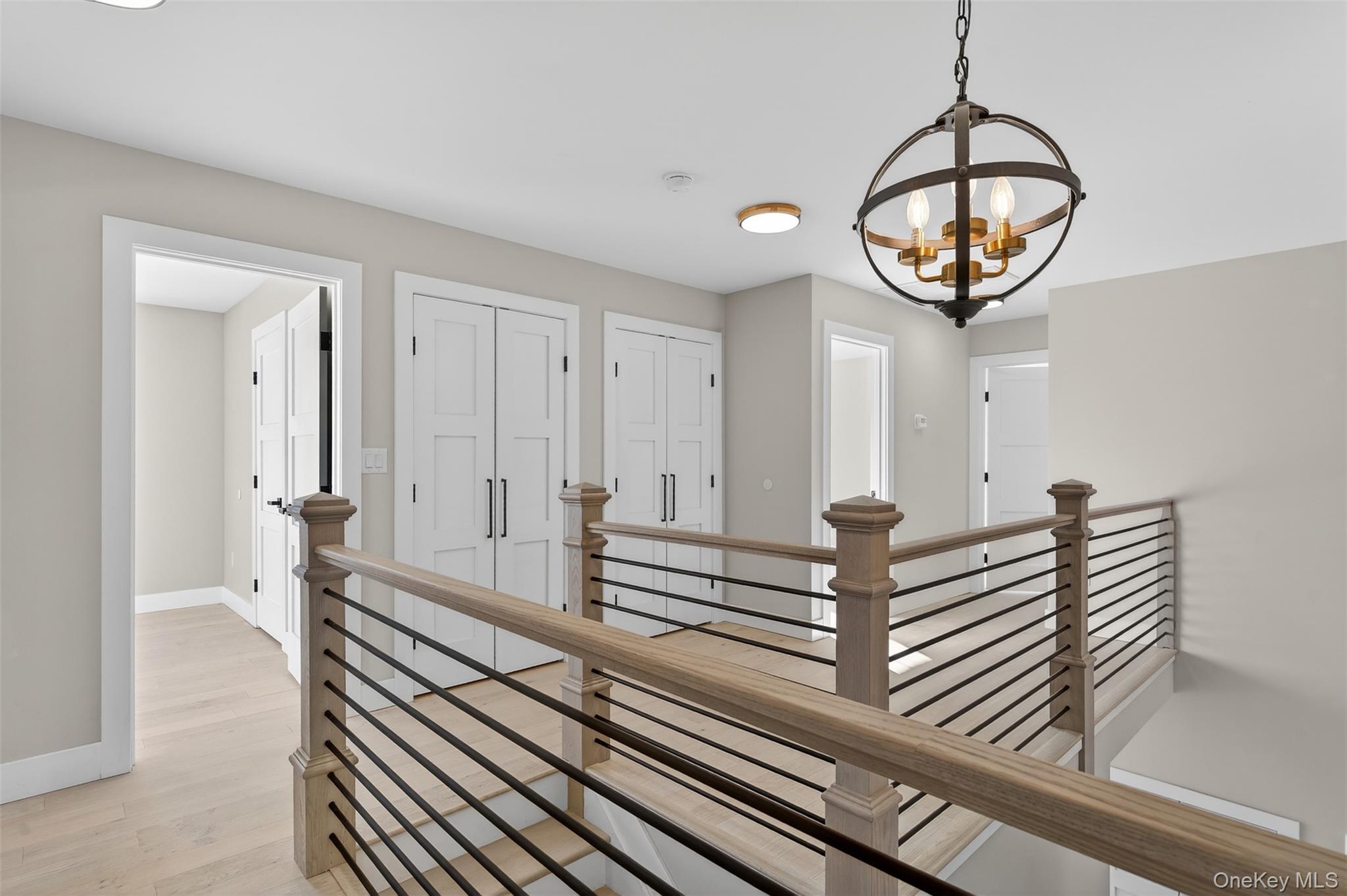 14 Harness Road Goshen, NY 10924 - Photo 23 of 40 Hall with an upstairs landing, light wood-style flooring, and a chandelier