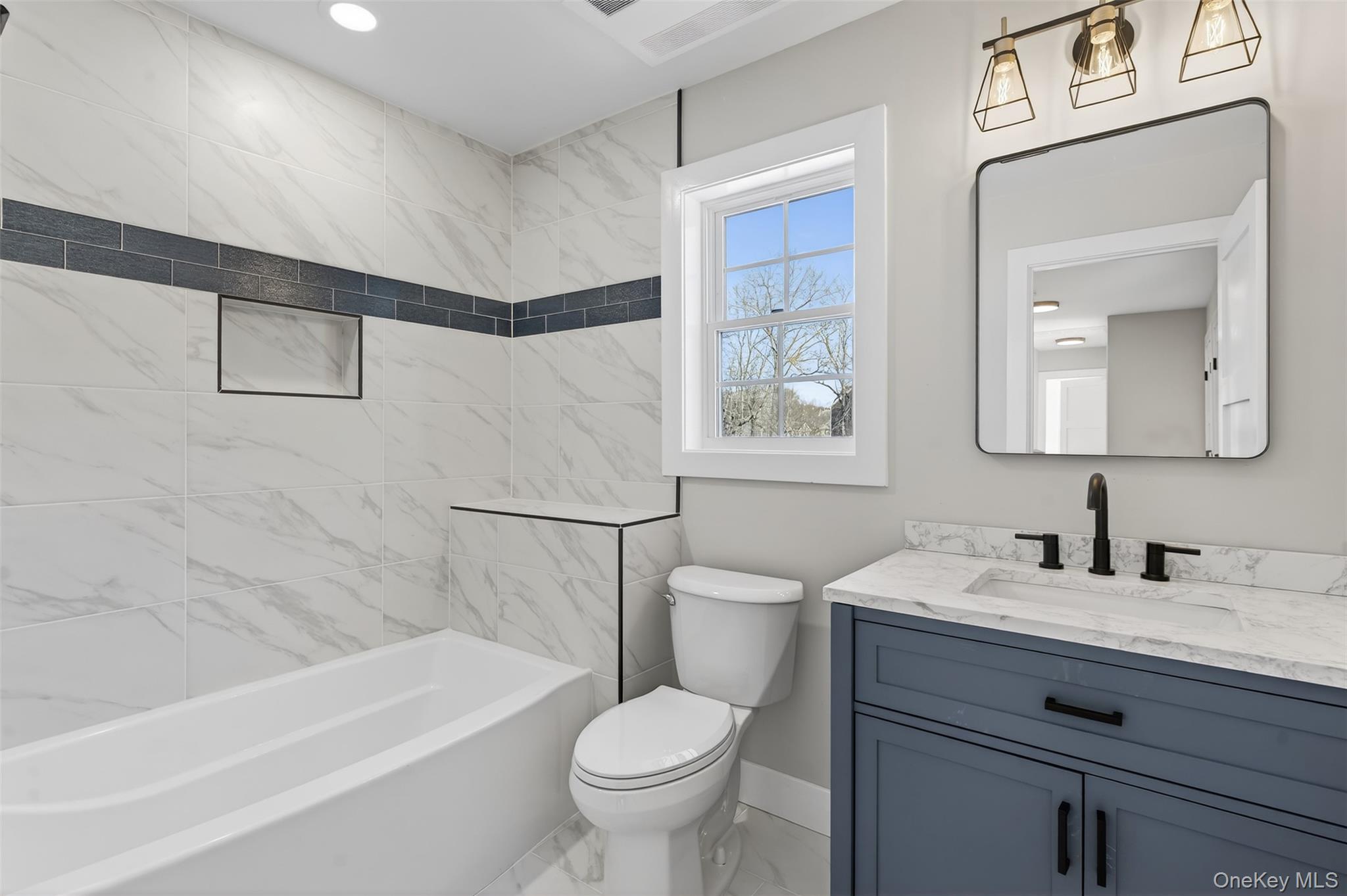 14 Harness Road Goshen, NY 10924 - Photo 24 of 40 Full bath featuring marble look tiles, vanity, and tub / shower combination