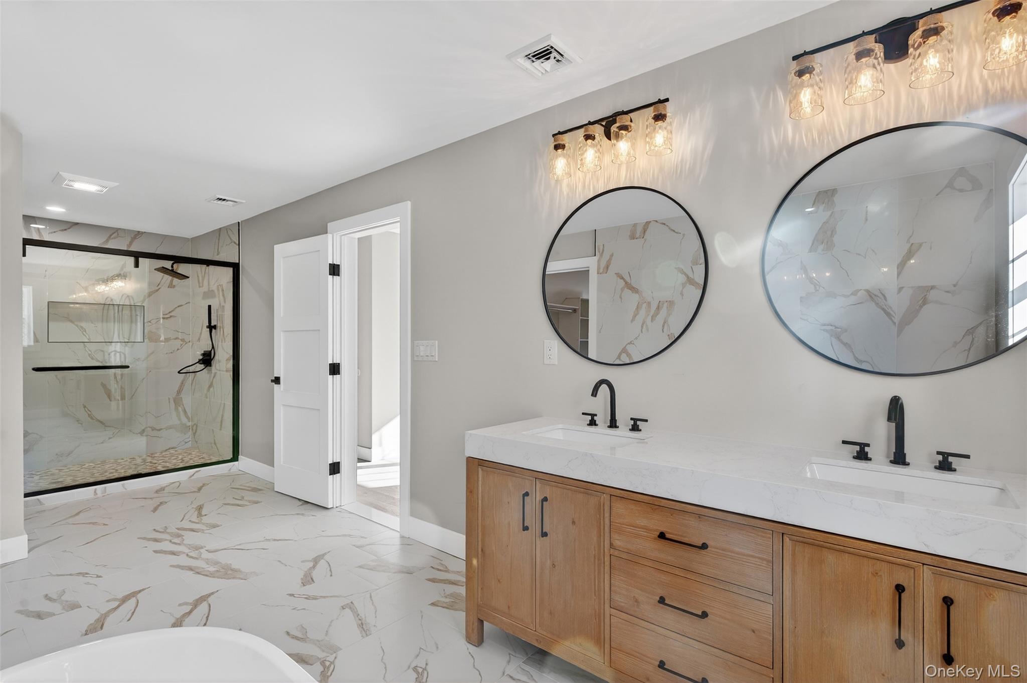 14 Harness Road Goshen, NY 10924 - Photo 33 of 40 Full bath featuring light marble finish flooring, a marble finish shower, double vanity, and a freestanding bath