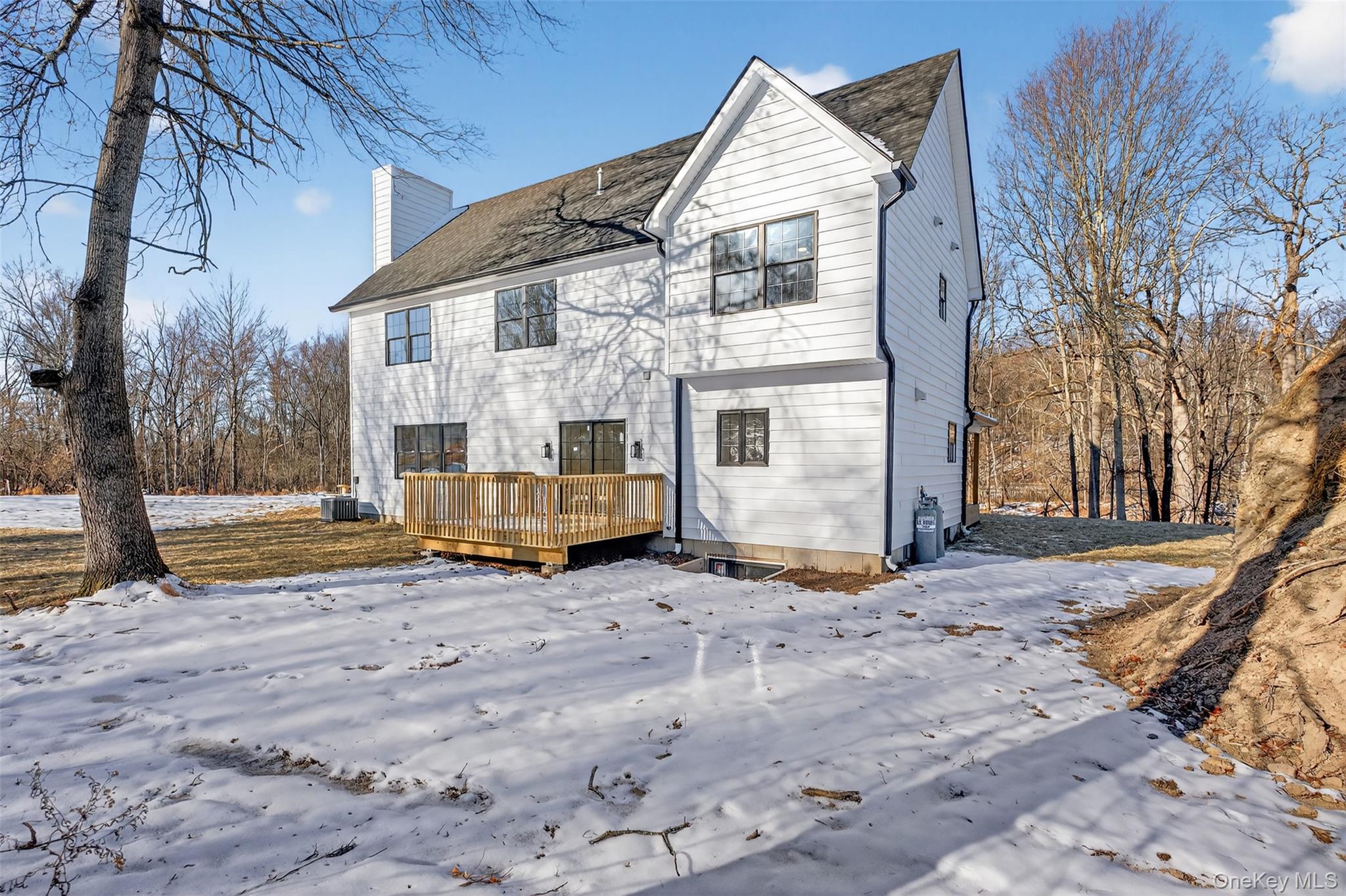 14 Harness Road Goshen, NY 10924 - Photo 4 of 40 Snow covered back of property featuring a wooden deck and a chimney
