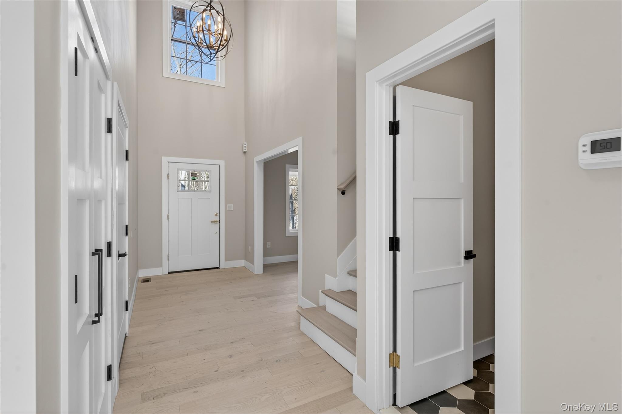 14 Harness Road Goshen, NY 10924 - Photo 9 of 40 Entrance foyer with a towering ceiling, stairs, a chandelier, and light wood-style floors