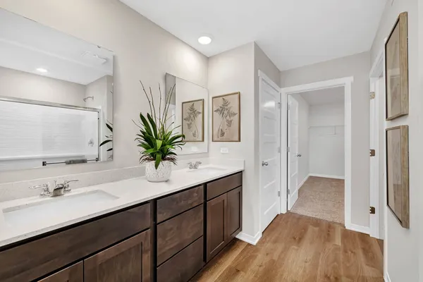 a bathroom with a double vanity sink and mirror