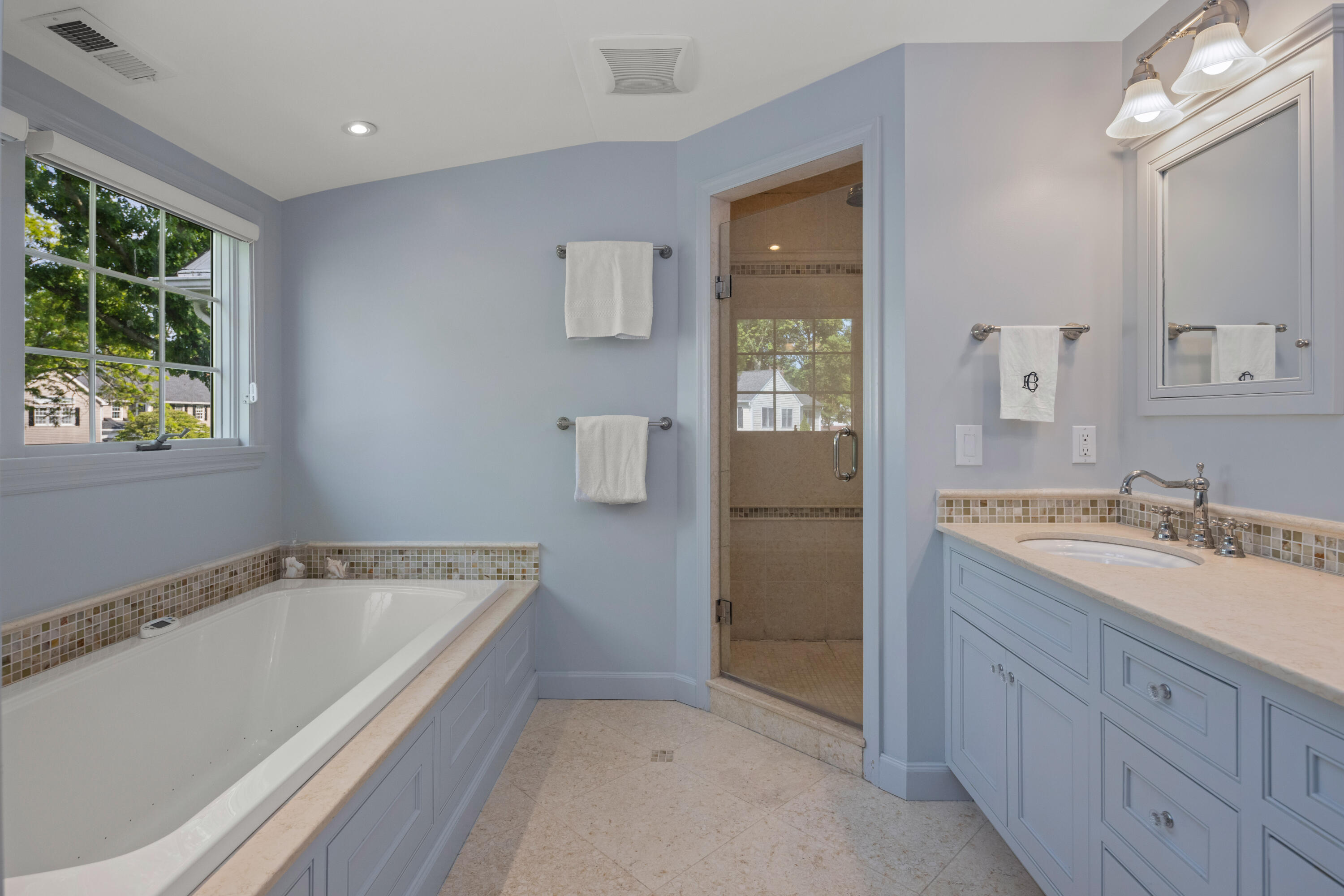 11 Lighthouse Way Darien, CT 06820 - Photo 17 of 25 a spacious bathroom with a tub sink and mirror
