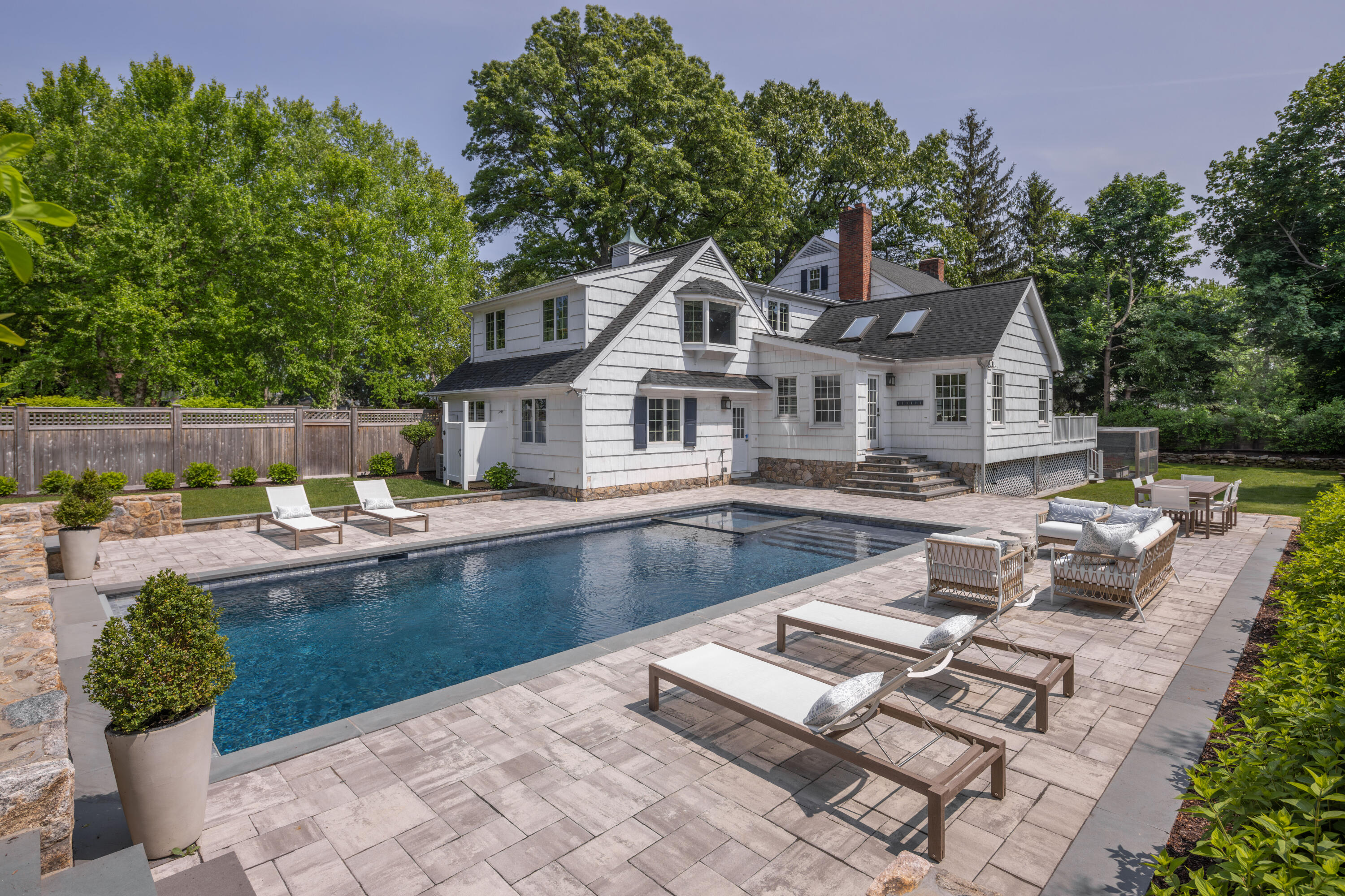 11 Lighthouse Way Darien, CT 06820 - Photo 4 of 25 a front view of a house with swimming pool and sitting area
